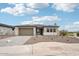 Exterior view featuring a two-car garage and covered entry of home with desert landscaping at 26361 N 76Th Dr, Peoria, AZ 85383