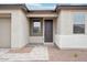Covered front entry featuring a dark wood door, a sidelight window, and neutral-colored pavers leading up to the entry at 26361 N 76Th Dr, Peoria, AZ 85383