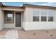 Covered front entry featuring a dark wood door, a sidelight window, and neutral-colored pavers leading up to the entry at 26361 N 76Th Dr, Peoria, AZ 85383