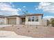 Charming single-story home with a well-manicured desert landscape and paved driveway leading to the two-car garage at 26361 N 76Th Dr, Peoria, AZ 85383