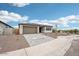 View of home's front yard featuring desert landscaping and a paved driveway leading to the two-car garage at 26361 N 76Th Dr, Peoria, AZ 85383