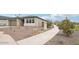 Street view of desert landscape with a charming single-story home with a well-manicured desert landscape at 26361 N 76Th Dr, Peoria, AZ 85383