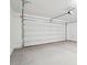 Clean and spacious garage with a modern roll-up door system at 26361 N 76Th Dr, Peoria, AZ 85383