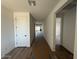 Bright hallway features wood-look tile flooring and white doors, creating a clean and inviting transition between rooms at 26361 N 76Th Dr, Peoria, AZ 85383