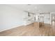 Spacious kitchen with wood flooring, white cabinets, stainless steel appliances, and a center island at 26361 N 76Th Dr, Peoria, AZ 85383
