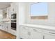 Well-lit kitchen featuring stainless steel appliances and white cabinetry at 26361 N 76Th Dr, Peoria, AZ 85383
