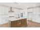 Gourmet kitchen featuring white cabinets, a central island, and stainless steel appliances, perfect for cooking at 26361 N 76Th Dr, Peoria, AZ 85383