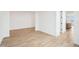 Bright living area with wood-style tile flooring and neutral wall paint at 26361 N 76Th Dr, Peoria, AZ 85383
