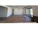 The spacious living room boasts tile floors and large sliding glass doors, inviting natural light and outdoor views at 26361 N 76Th Dr, Peoria, AZ 85383