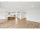 Open-concept living room showcasing wood-look flooring, recessed lighting, and a modern island kitchen at 26361 N 76Th Dr, Peoria, AZ 85383
