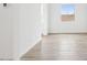 Bright living area with wood-style tile flooring and a view of the neighborhood at 26361 N 76Th Dr, Peoria, AZ 85383