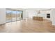 Bright living room with sliding glass doors to backyard and views, flowing into a stylish, modern kitchen at 26361 N 76Th Dr, Peoria, AZ 85383