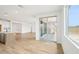 Open living space with wood-look floors, an island kitchen, and sliding doors, ideal for entertaining at 26361 N 76Th Dr, Peoria, AZ 85383