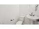 A minimalist powder room featuring a pedestal sink and modern toilet at 26361 N 76Th Dr, Peoria, AZ 85383
