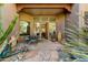 Inviting covered front patio with stone flooring and comfortable seating area at 27502 N Azatlan Dr, Rio Verde, AZ 85263