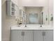 Bathroom featuring double sinks, lots of cabinetry and an oversized mirror at 2820 E Tracy Ln # 1, Phoenix, AZ 85032