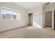 Bright bedroom with carpeting, closet, and a large window with an exterior view at 2820 E Tracy Ln # 1, Phoenix, AZ 85032