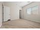 Bright bedroom with neutral carpet, a window with blinds, and a walk-in closet at 2820 E Tracy Ln # 1, Phoenix, AZ 85032