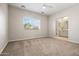 Bright bedroom with an ensuite bathroom, neutral tones, and a large window at 2820 E Tracy Ln # 1, Phoenix, AZ 85032