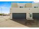 Modern home exterior featuring a three car garage and textured stucco at 2820 E Tracy Ln # 1, Phoenix, AZ 85032