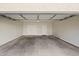 Clean, empty garage with a two white doors and a center light at 2820 E Tracy Ln # 1, Phoenix, AZ 85032
