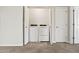 Bright laundry room with a washer and dryer inside a closet, next to a door at 2820 E Tracy Ln # 1, Phoenix, AZ 85032