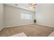 Neutral living room with carpet flooring and a ceiling fan at 2820 E Tracy Ln # 1, Phoenix, AZ 85032