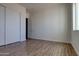 Bedroom with a large window, closet, and neutral color scheme at 29120 N 257Th Dr, Wittmann, AZ 85361