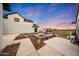 Serene backyard with a stylish fire pit area surrounded by lush landscaping and an inviting ambiance at 29617 W Eagle Dr, Palo Verde, AZ 85343