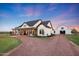 Beautiful exterior shot showing the home and barn with long driveway and landscaping at 29617 W Eagle Dr, Palo Verde, AZ 85343