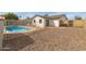 Backyard with a small in-ground swimming pool and surrounding stone landscaping at 313 W Palomino Dr, Chandler, AZ 85225