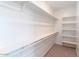 Walk-in closet with shelving and hanging rods offering ample storage space at 36805 W San Clemente St, Maricopa, AZ 85138