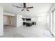 Open concept living space with tile floors, natural light, and kitchen view at 36805 W San Clemente St, Maricopa, AZ 85138