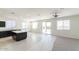 Open concept living space with tile floors, natural light, and kitchen view at 36805 W San Clemente St, Maricopa, AZ 85138