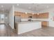 Bright kitchen featuring an island, stainless steel appliances, and wood cabinets at 3769 W Antelope Way, San Tan Valley, AZ 85144