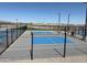 View of the community pickleball court surrounded by black fencing at 36805 W San Clemente St, Maricopa, AZ 85138
