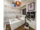 Luxurious bathroom with a freestanding tub, artful chandelier, and unique decorative accents at 38951 N 101St Way, Scottsdale, AZ 85262