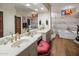 Bright bathroom showcasing dual vanities, artistic decor, and a luxurious tub and shower at 38951 N 101St Way, Scottsdale, AZ 85262