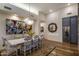 Unique dining room with an eclectic painting, modern lighting, and whimsical chairs for stylish entertaining at 38951 N 101St Way, Scottsdale, AZ 85262