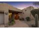 Exterior of the home's front entrance with decorative landscaping and a tiled walkway at 38951 N 101St Way, Scottsdale, AZ 85262
