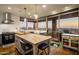 Open kitchen with a large island, stainless steel range hood, and expansive windows that offer breathtaking outdoor vistas at 38951 N 101St Way, Scottsdale, AZ 85262