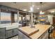 Bright kitchen showcasing a wooden island, white farmhouse sink, and expansive windows with scenic outdoor views at 38951 N 101St Way, Scottsdale, AZ 85262