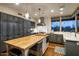 Modern kitchen featuring gray cabinetry, a large center island with wooden countertop, and stainless steel appliances at 38951 N 101St Way, Scottsdale, AZ 85262