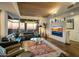 Comfortable living room boasting a leather sectional, unique lighting, and floor-to-ceiling windows with stunning views at 38951 N 101St Way, Scottsdale, AZ 85262