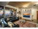 Stylish living room with a leather sectional, glass coffee table, and large windows showcasing the desert landscape at 38951 N 101St Way, Scottsdale, AZ 85262