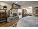 Bright bedroom with a stone fireplace and an access to an outdoor patio at 38951 N 101St Way, Scottsdale, AZ 85262