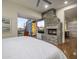 Inviting bedroom featuring a stone fireplace and an access to a modern bathroom at 38951 N 101St Way, Scottsdale, AZ 85262