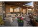 Covered outdoor patio area with comfortable seating and views of the desert landscape at 38951 N 101St Way, Scottsdale, AZ 85262
