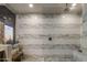 Modern shower featuring marble-style tile walls, a glass enclosure, and a built-in bench at 38951 N 101St Way, Scottsdale, AZ 85262