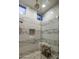 Modern shower featuring marble-style tile walls, a glass enclosure, and a built-in bench at 38951 N 101St Way, Scottsdale, AZ 85262